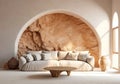 Mediterranean interior design of modern living room with beige sofa and arched wall with stucco and sandstone wall finishes.
