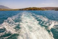 Mediterranean landscape with wave pattern on water surface behind boat. Montenegro, Bay of Kotor, Adriatic Sea Royalty Free Stock Photo