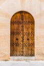 Mediterranean mansion brown wooden entrance door with stone arch, close-up Royalty Free Stock Photo