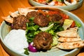 Mediterranean meatballs with salad, chickpeas with tomato sauce, yogurt dip and pita bread