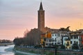 Mediterranean old city with church tower at river by sunset Royalty Free Stock Photo