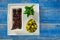 Mediterranean pickles black olives and mint leaves