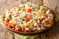 Mediterranean rice with canned tuna and fresh vegetables close-up in a plate. horizontal