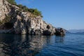 Mediterranean rocky shores and landscape. View from sea. Rock reflection in blue water sea.