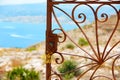 Mediterranean rusted gate with sea in background Royalty Free Stock Photo