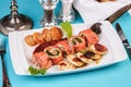 Mediterranean salmon rolls with cheese and greens in chili sauce, served with pancakes and buns Royalty Free Stock Photo