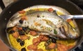 Mediterranean sea bass, with cherry tomatoes, olives and capers Royalty Free Stock Photo
