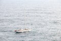 Aerial view of beautiful white sailboat in blue sea at bright sunny summer day. Royalty Free Stock Photo