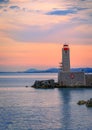 Mediterranean Sea with the lighthouse at sunset in the harbor, N Royalty Free Stock Photo