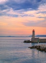 Mediterranean Sea with the lighthouse at sunset in the harbor, N Royalty Free Stock Photo