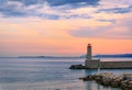 Mediterranean Sea with the lighthouse at sunset in the harbor, Nice, France Royalty Free Stock Photo