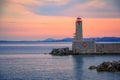 Mediterranean Sea with the lighthouse at sunset in the harbor, Nice, France Royalty Free Stock Photo