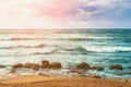 Mediterranean sea nature landscape panorama, azure sea water, sandy beach with rock stones and sunset cloudy sky