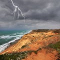 Mediterranean sea panoramic landscape with high sandy cliff coast. Lightning sparkling in thunder sky Royalty Free Stock Photo