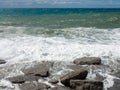 Mediterranean Sea waves crashing over rocks on a beach in stormy weather Royalty Free Stock Photo