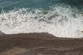 Mediterranean sea waves on a pebble beach on a sunny day Royalty Free Stock Photo