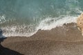 Mediterranean sea waves on a pebble beach on a sunny day Royalty Free Stock Photo