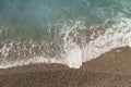 Mediterranean sea waves on a pebble beach on a sunny day Royalty Free Stock Photo