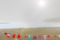 Mediterranean seaside beach with national flags strung in foreg