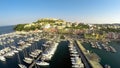 Mediterranean seaside town aerial shot, boats docked in port, summer vacation Royalty Free Stock Photo