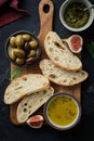 Mediterranean snacks set. Olives, oil, herbs and sliced ciabatta bread. Top view.