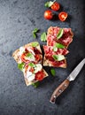 Mediterranean-style ciabatta sandwiches with salami, dried tomatoes, gorgonzola and cherry tomatoes