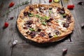 Mediterranean style flatbread pizza, on wood table, close-up, selective focus. Baked flatbread with Italian ingredients.
