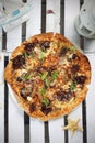 Mediterranean style flatbread pizza, on a white wooden boards. Freshly baked flatbread on a table, top view.