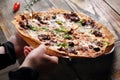 Mediterranean style flatbread pizza, on wood table, close-up, selective focus. Baked flatbread with Italian ingredients.