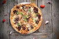 Mediterranean style flatbread pizza, on a wooden table, top view. Freshly baked flatbread with Italian ingredients.