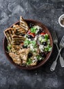 Mediterranean style lunch - couscous, cherry tomatoes, cucumbers, feta cheese, olives salad and lemon herbs roasted chicken breast Royalty Free Stock Photo