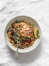 Mediterranean style lunch - orzo with mushrooms, dried tomatoes, spinach and roasted chicken breast on a light background, top Royalty Free Stock Photo