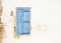 Mediterranean style old window. Blue on light wall