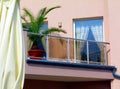 Mediterranean style roof terrace and pation with small palm. glas balustrade