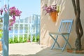 Mediterranean style terrace with sea scape, chair, flowers. Royalty Free Stock Photo