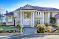 Mediterranean style waterfront home with stucco walls and columned porch