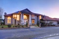 Mediterranean style waterfront home with stucco walls and columned porch Royalty Free Stock Photo