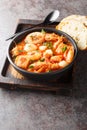 Mediterranean thick stew of seafood and fish with tomatoes close-up in a bowl. Vertical