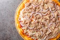 Mediterranean traditional Pizza Tuna with tomato sauce, canned tuna, mozzarella cheese and red onion close-up on a wooden board. Royalty Free Stock Photo