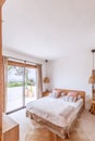 Mediterranean villa guest bedroom in beige tones, wicker chandeliers, linens in local style and colors