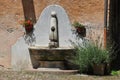 Mediterranean water fountain, lavender and geranium flower Royalty Free Stock Photo