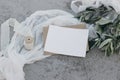 Mediterranean wedding stationery mock-up still life. Blank greeting card, invitation template. White silk ribbon, table