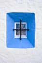 Mediterranean window with dried plant and rough white wall partl