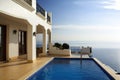 mediterrnean house exterior, with view of the sea or pool in the background Royalty Free Stock Photo