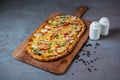 Meditranean Pizza with black pepper serving on wooden cutting board isolated on grey background top view of fastfood Royalty Free Stock Photo