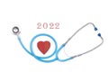 Meditsin stethoscope on a white background in the middle of a red heart, the concept of heart disease, 2022