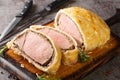 Medium Beef Wellington classic sliced steak closeup on wooden board. Horizontal