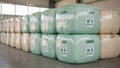 Medium distance view capturing stacked bales wrapped in different biobased materials including a translucent green wrap Royalty Free Stock Photo