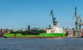 Green supply ship in a shipyard.