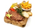 Fine Meat - Medium Grilled Beef Steak on a wooden Board with Potato Wedges Royalty Free Stock Photo